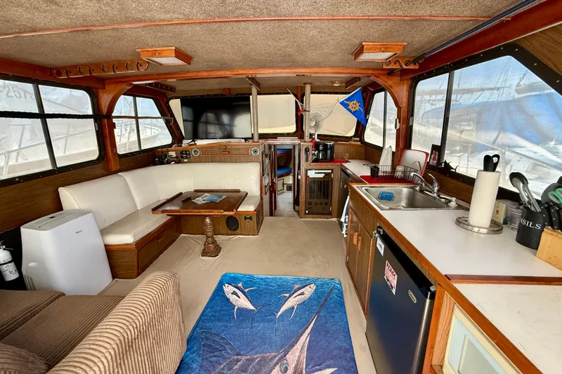 Slide: The Image of Interior of a 1971 Pacifica 44 Convertible boat with cozy seating and kitchenette. - 36