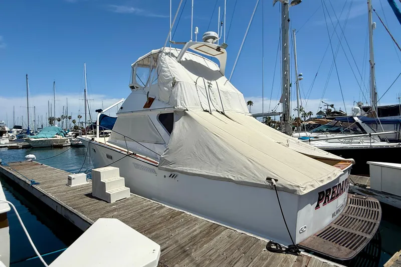 Slide: The Image of 1971 Pacifica 44 Convertible yacht docked at marina, covered with protective tarp. - 4