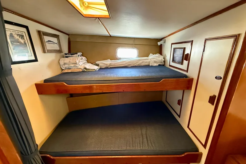 Slide: The Image of Interior of a 1971 Pacifica 44 Convertible boat with cozy seating and nautical decor. - 43