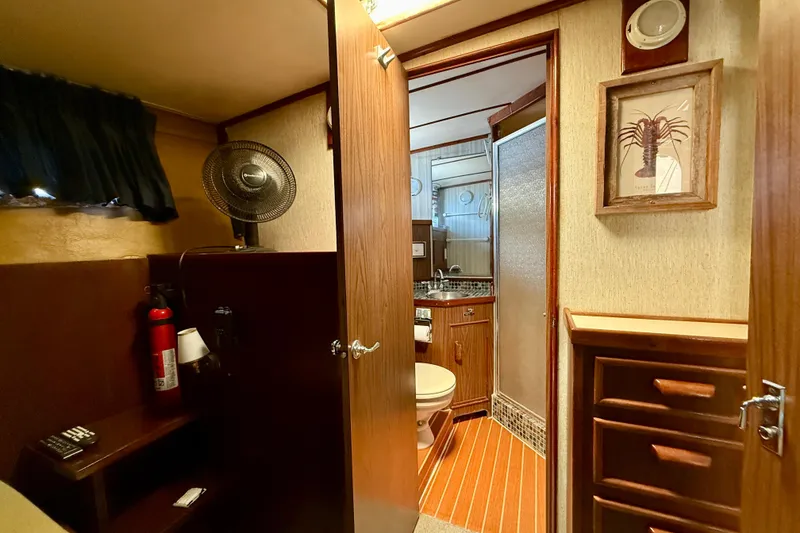 Slide: The Image of Interior cabin of 1971 Pacifica 44 Convertible with bed, TV, and fish artwork. - 45