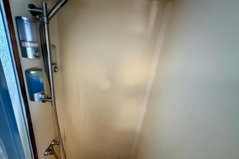 Slide: The Image of 1971 Pacifica 44 Convertible yacht bathroom with wood paneling and mosaic countertop. - 47