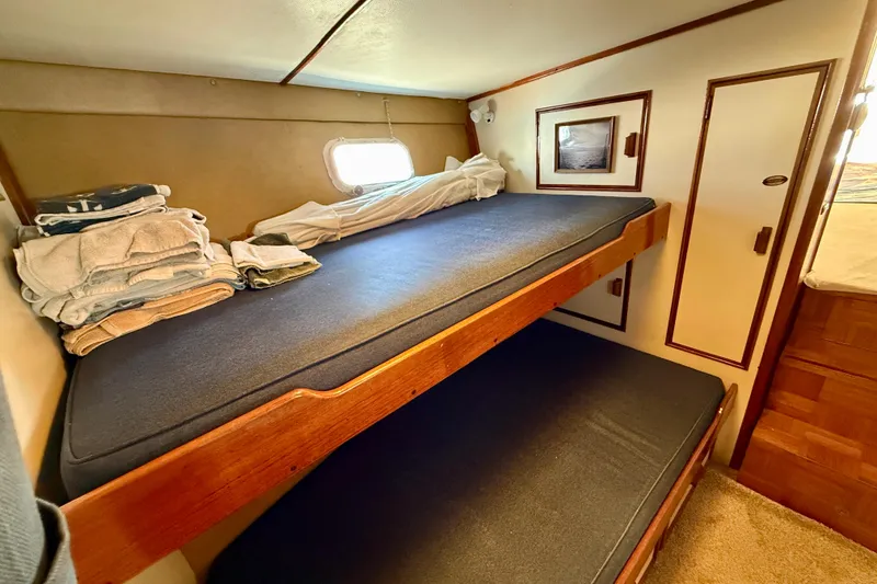 Slide: The Image of 1971 Pacifica 44 Convertible cabin with wooden bunk beds and nautical decor. - 49