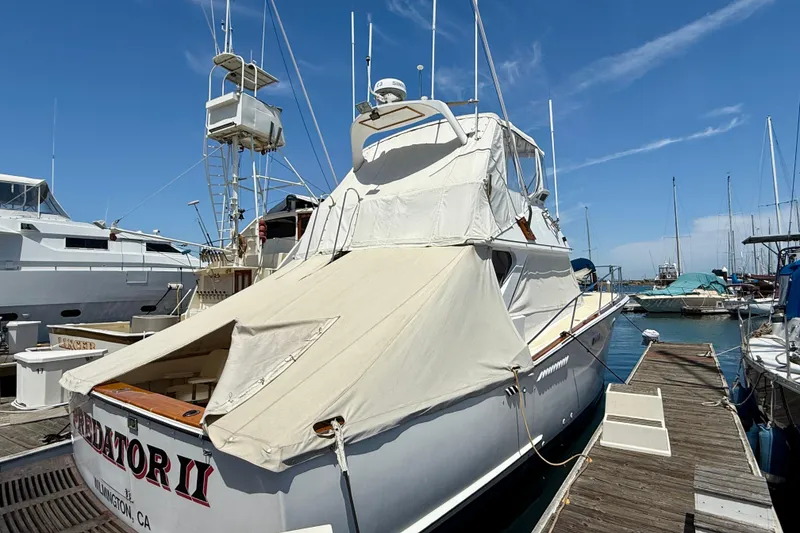 Slide: The Image of 1971 Pacifica 44 Convertible yacht docked at marina under clear blue sky. - 6