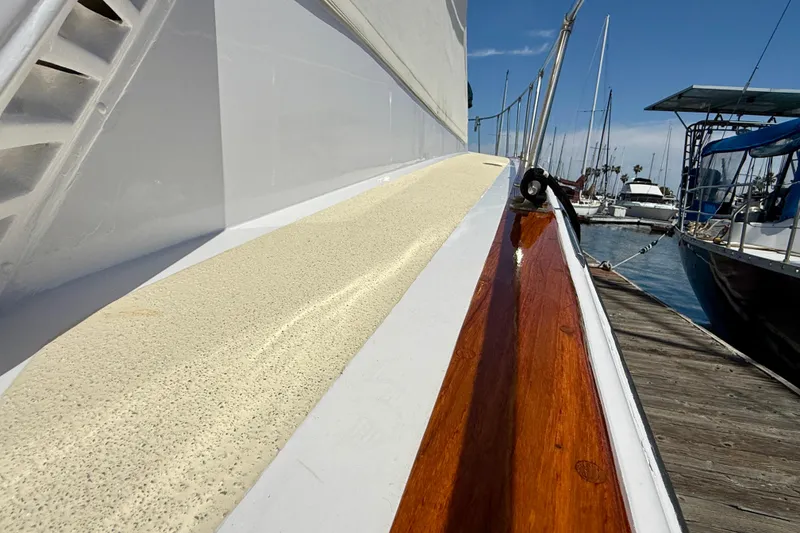 Slide: The Image of 1971 Pacifica 44 Convertible yacht docked, showcasing polished wood and textured deck surface. - 7