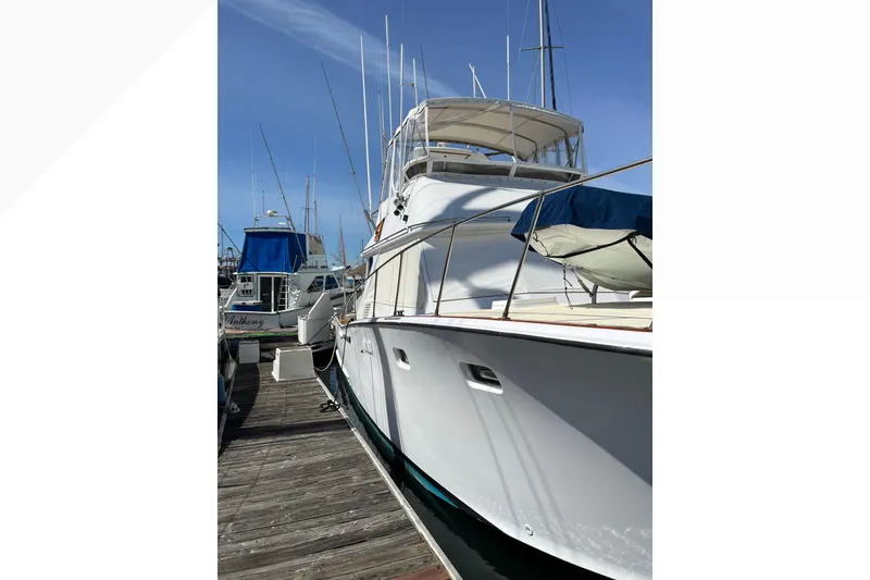 Slide: The Image of 1971 Pacifica 44 Convertible yacht docked at marina under clear blue sky. - 9