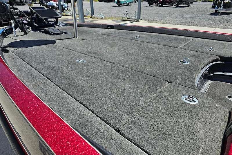 Slide: The Image of 2015 Ranger Z521 Comanche boat deck with carpeted surface and fishing equipment. - 11