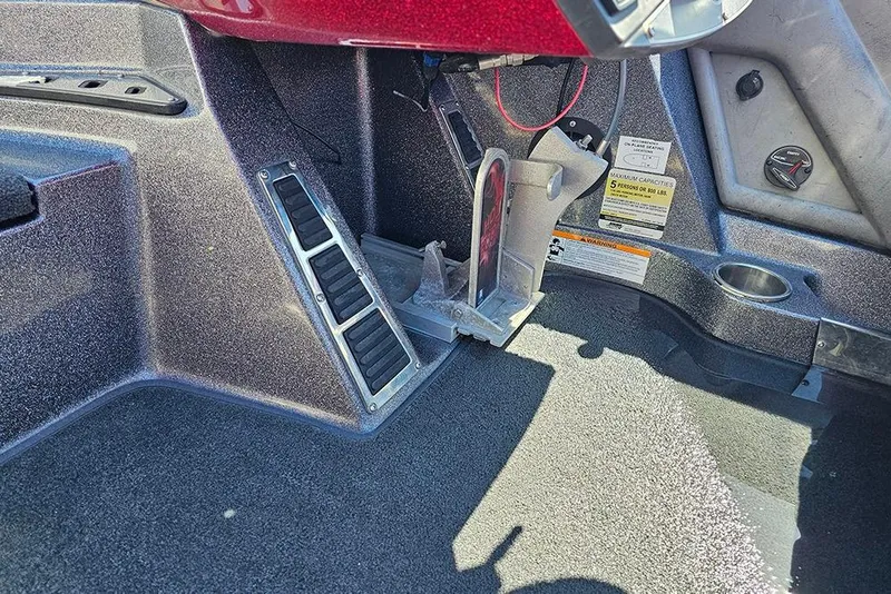 Slide: The Image of Interior view of a 2015 Ranger Z521 Comanche boat cockpit with foot pedal controls. - 15