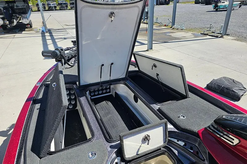 Slide: The Image of 2015 Ranger Z521 Comanche boat storage compartments open at a marina. - 16