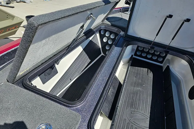 Slide: The Image of Open storage compartments on a 2015 Ranger Z521 Comanche boat, showcasing interior design. - 17