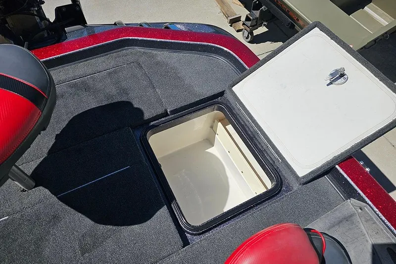 Slide: The Image of 2015 Ranger Z521 Comanche boat storage compartment with open hatch and red seat. - 26