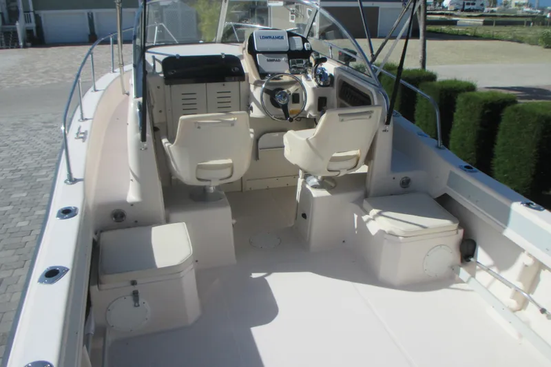 Slide: The Image of 1998 Grady-White Adventure 208 boat interior with helm and seating area. - 11