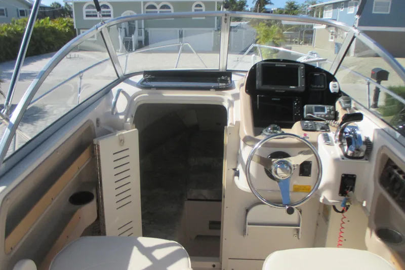 Slide: The Image of Interior view of 1998 Grady-White Adventure 208 boat cockpit with steering wheel and controls. - 12