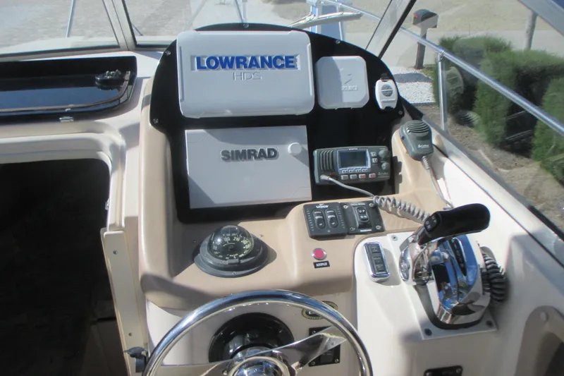 Slide: The Image of 1998 Grady-White Adventure 208 boat dashboard with Lowrance and Simrad navigation systems. - 13