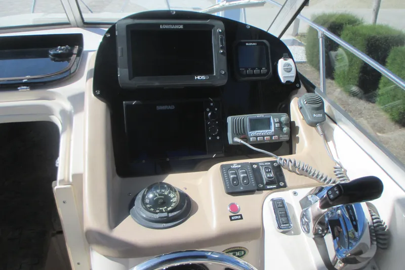 Slide: The Image of Control panel of a 1998 Grady-White Adventure 208 boat with navigation equipment. - 14