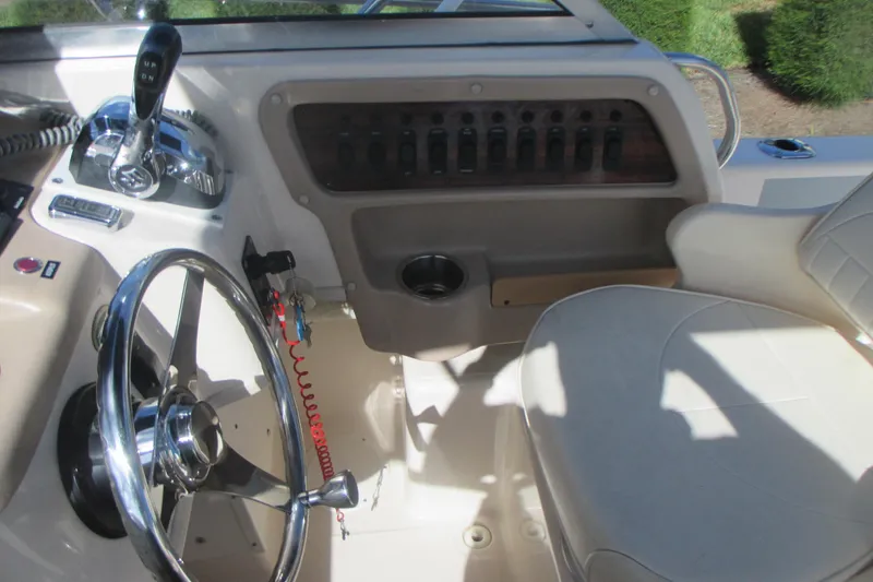 Slide: The Image of Interior view of 1998 Grady-White Adventure 208 boat cockpit with steering wheel and controls. - 15