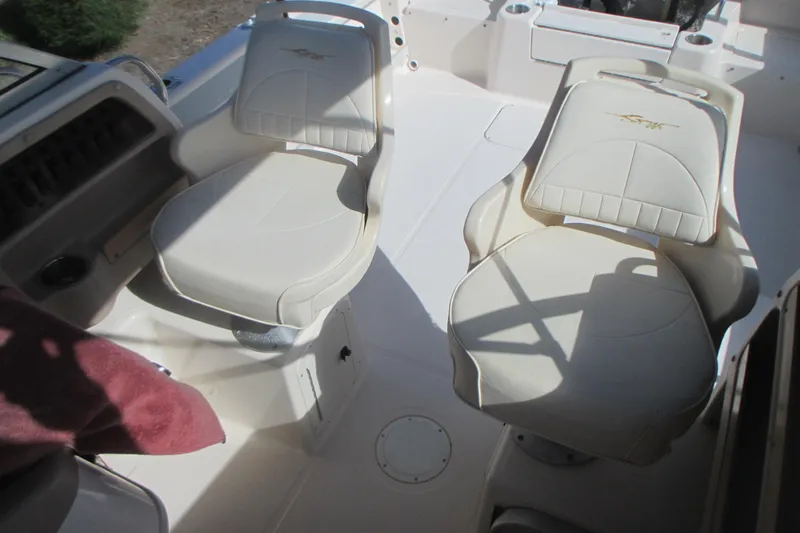 Slide: The Image of 1998 Grady-White Adventure 208 boat interior with two white cushioned seats. - 16