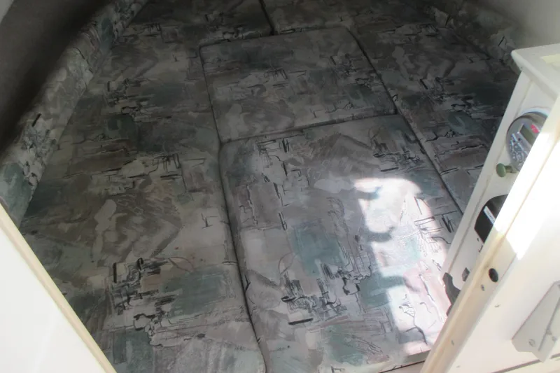 Slide: The Image of Interior cabin of a 1998 Grady-White Adventure 208 boat with patterned cushions. - 17