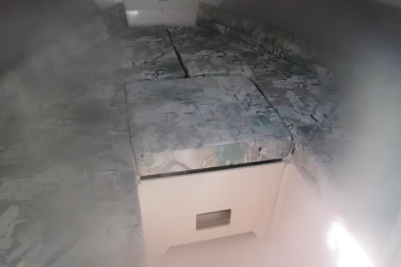 Slide: The Image of Interior cabin of 1998 Grady-White Adventure 208 boat with patterned cushions. - 18