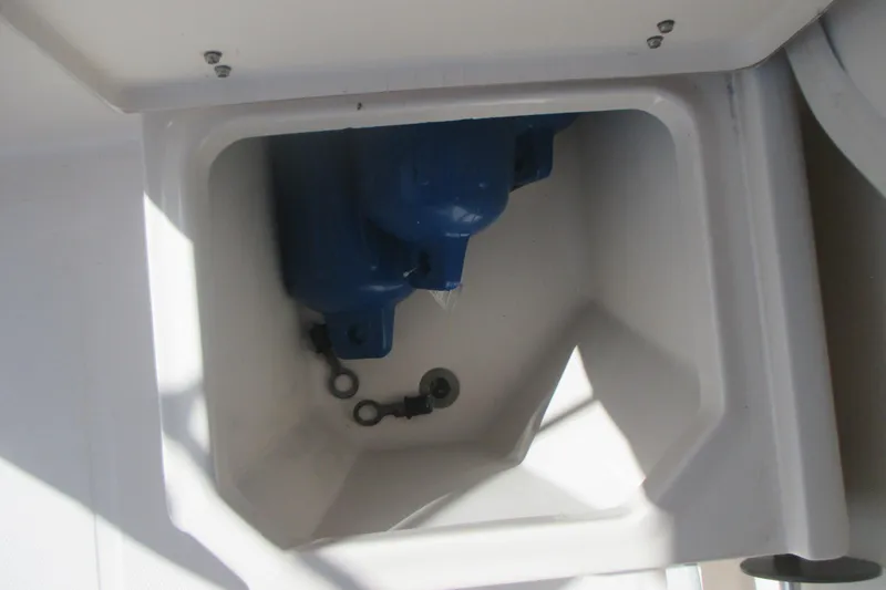 Slide: The Image of Storage compartment in 1998 Grady-White Adventure 208 boat with blue equipment inside. - 20
