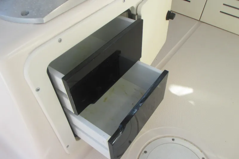 Slide: The Image of Open storage compartment on 1998 Grady-White Adventure 208 boat interior. - 22
