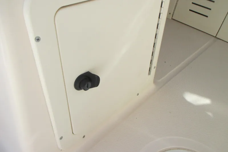 Slide: The Image of Compartment door on a 1998 Grady-White Adventure 208 boat interior. - 23