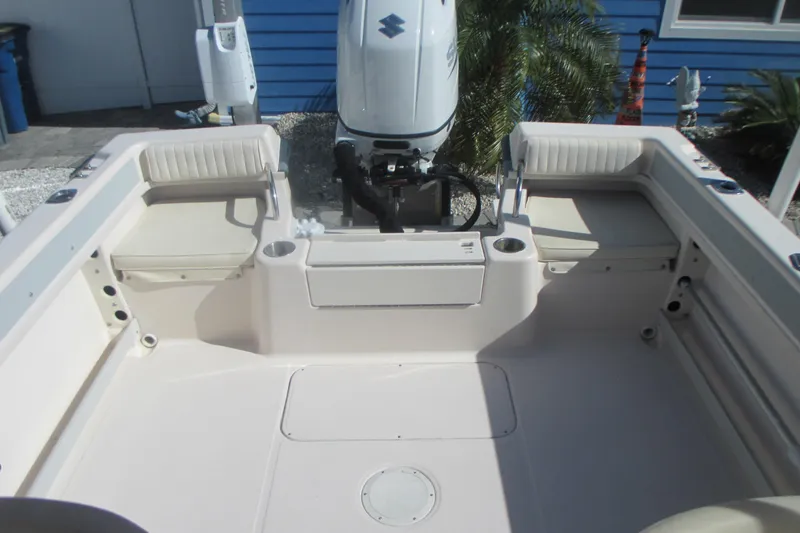 Slide: The Image of 1998 Grady-White Adventure 208 boat interior with seating and outboard motor. - 24