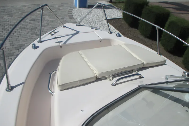 Slide: The Image of 1998 Grady-White Adventure 208 boat deck with cushioned seating and railings. - 29