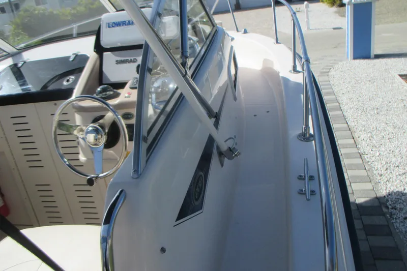 Slide: The Image of 1998 Grady-White Adventure 208 boat interior with steering wheel and navigation equipment. - 30