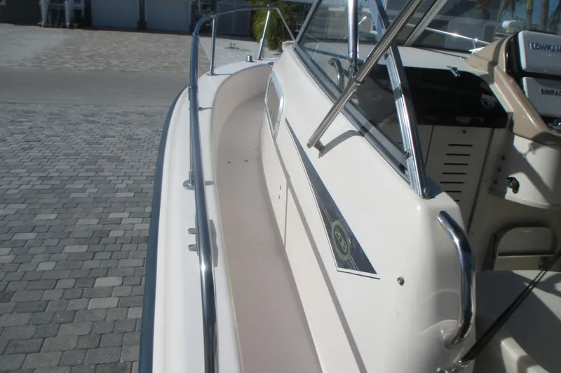 Slide: The Image of 1998 Grady-White Adventure 208 boat, side view with railing and cockpit details. - 31