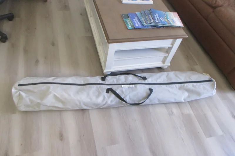 Slide: The Image of Long white bag on wooden floor beside a coffee table with magazines. - 32