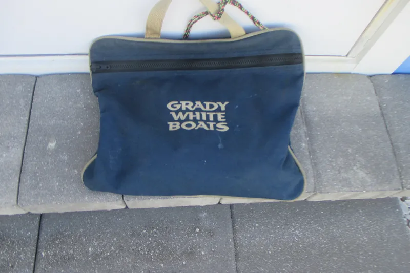 Slide: The Image of Blue Grady-White Boats bag on pavement, related to 1998 Adventure 208 model. - 34