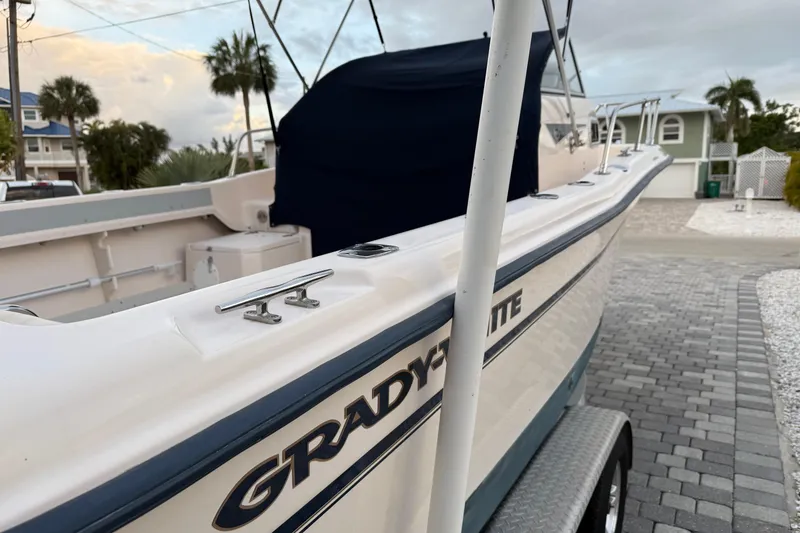 Slide: The Image of 1998 Grady-White Adventure 208 boat on a trailer, parked in a coastal neighborhood. - 5