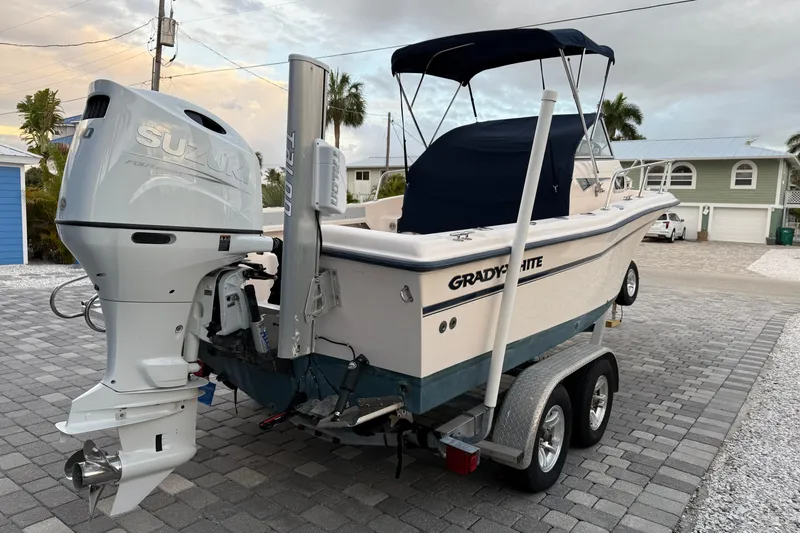 Slide: The Image of 1998 Grady-White Adventure 208 boat with Suzuki outboard motor on trailer. - 8