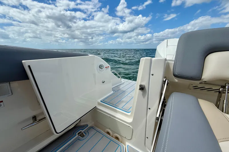 Slide: The Image of Boston Whaler 350 Realm 2025 boat interior with ocean view and open hatch. - 12