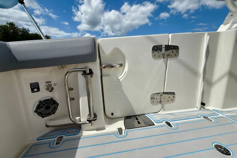 Slide: The Image of 2025 Boston Whaler 350 Realm boat deck with seating, speaker, and stainless steel railing. - 20