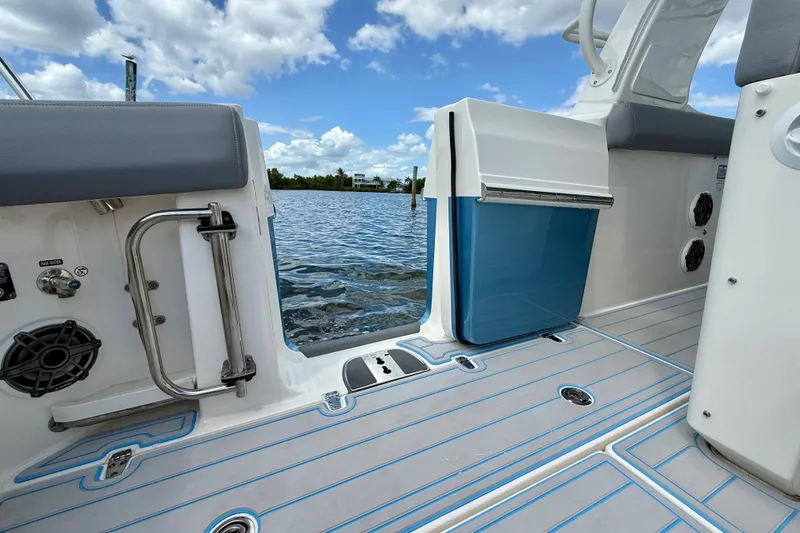 Slide: The Image of Boston Whaler 350 Realm 2025 boat interior with open door, lake view, and blue skies. - 21