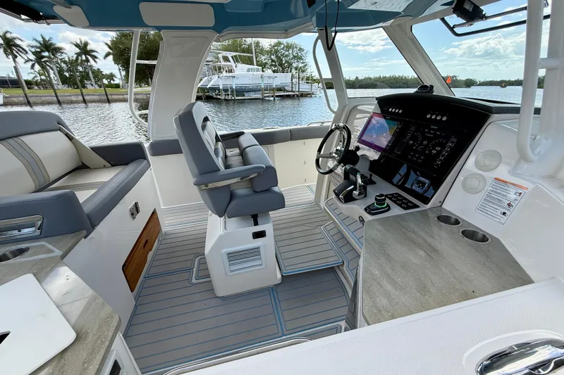 Slide: The Image of 2025 Boston Whaler 350 Realm boat interior with modern helm and seating. - 32