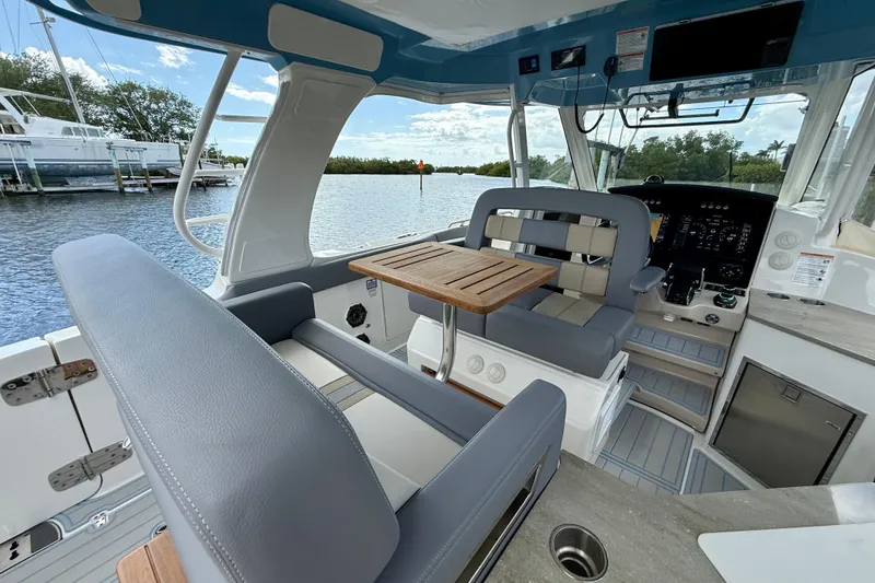 Slide: The Image of Interior of 2025 Boston Whaler 350 Realm boat with seating and control panel. - 33