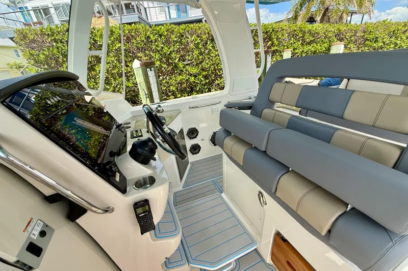 Slide: The Image of 2025 Boston Whaler 350 Realm cockpit with modern helm and comfortable seating. - 36