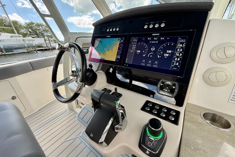Slide: The Image of Cockpit of 2025 Boston Whaler 350 Realm with advanced navigation displays and controls. - 38