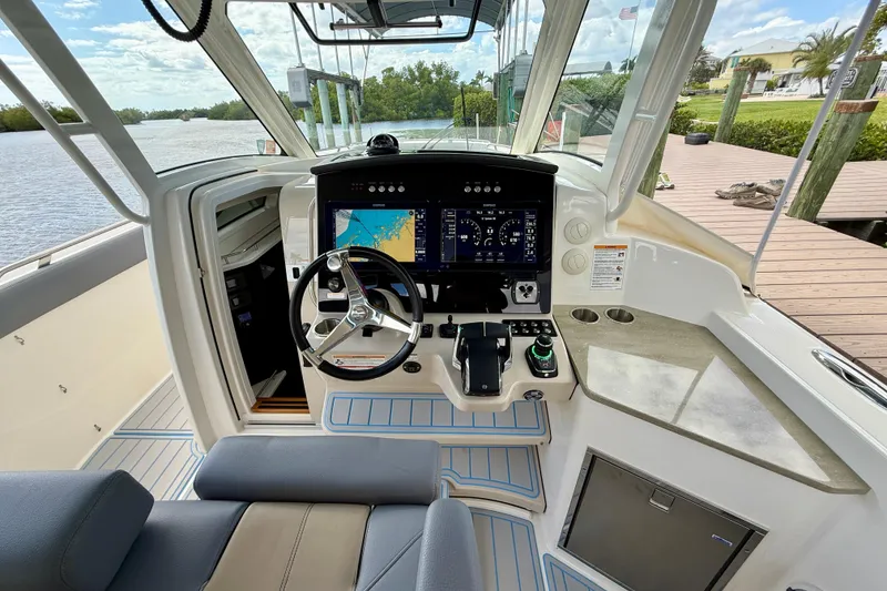 Slide: The Image of 2025 Boston Whaler 350 Realm cockpit with advanced navigation system and luxurious seating. - 39