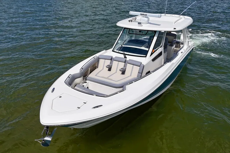 Slide: The Image of 2025 Boston Whaler 350 Realm cruising on clear waters, showcasing sleek design and luxury features. - 4