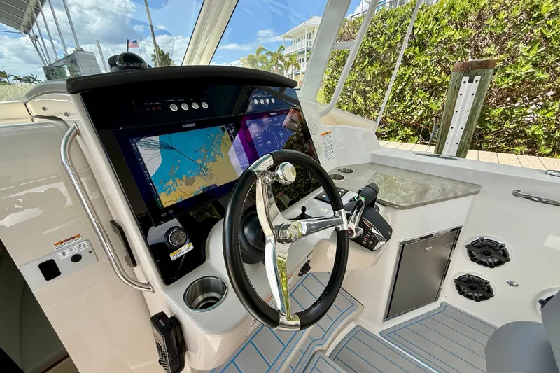 Slide: The Image of 2025 Boston Whaler 350 Realm helm with advanced navigation displays and controls. - 41