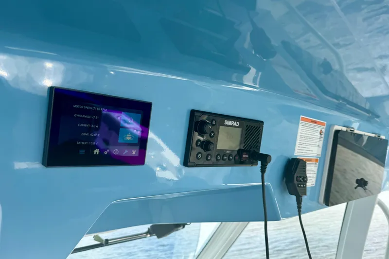 Slide: The Image of Control panel of 2025 Boston Whaler 350 Realm with digital displays and navigation equipment. - 42