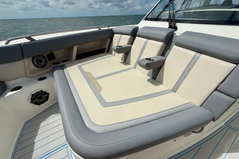 Slide: The Image of Luxurious seating on the 2025 Boston Whaler 350 Realm boat, featuring cup holders and speakers. - 44