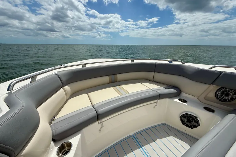 Slide: The Image of 2025 Boston Whaler 350 Realm boat interior with ocean view, featuring cushioned seating. - 45