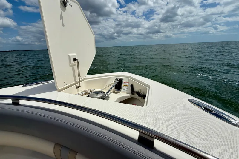 Slide: The Image of Boston Whaler 350 Realm 2025 boat on open water, anchor compartment open. - 47
