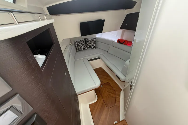 Slide: The Image of Luxurious interior of 2025 Boston Whaler 350 Realm with modern seating and wood flooring. - 49