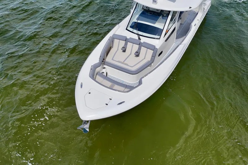 Slide: The Image of 2025 Boston Whaler 350 Realm boat on green water, aerial view. - 5