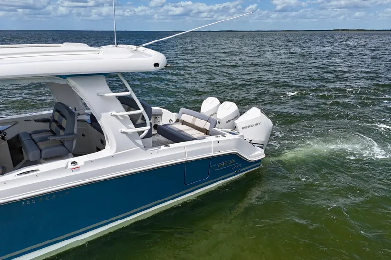 Slide: The Image of 2025 Boston Whaler 350 Realm cruising on open water, showcasing sleek design and powerful engines. - 9